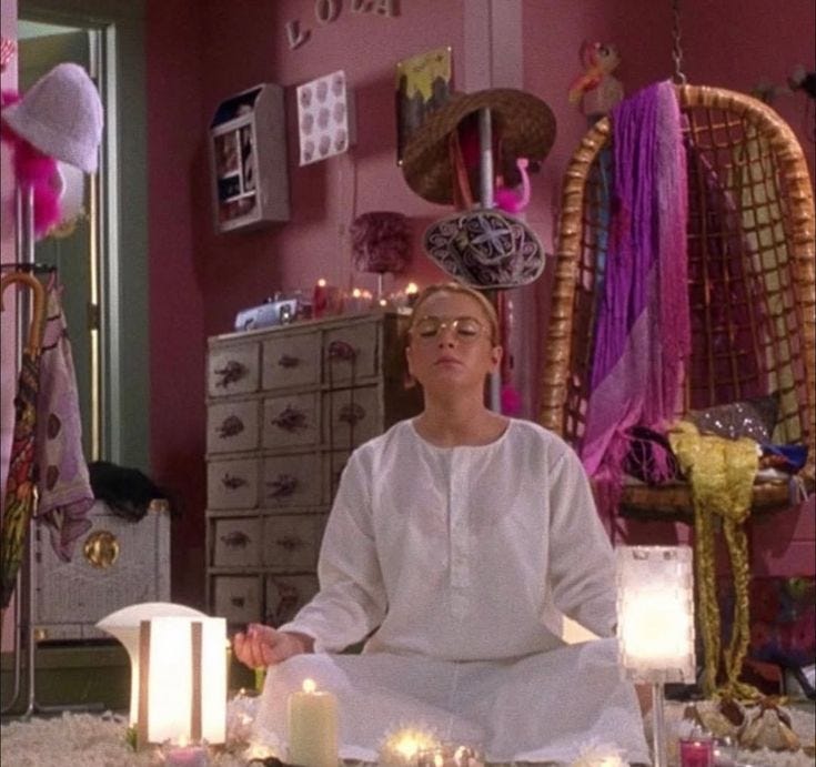 This may contain: a person sitting in a room with candles and decorations on the floor next to them This may contain: a person sitting in a room with candles and decorations on the floor next to them