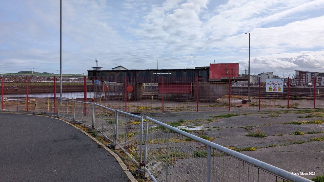 A fenced off area with boarding ramps in the background A fenced off area with boarding ramps in the background