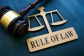 A gavel and a sign with scales

Description automatically generated