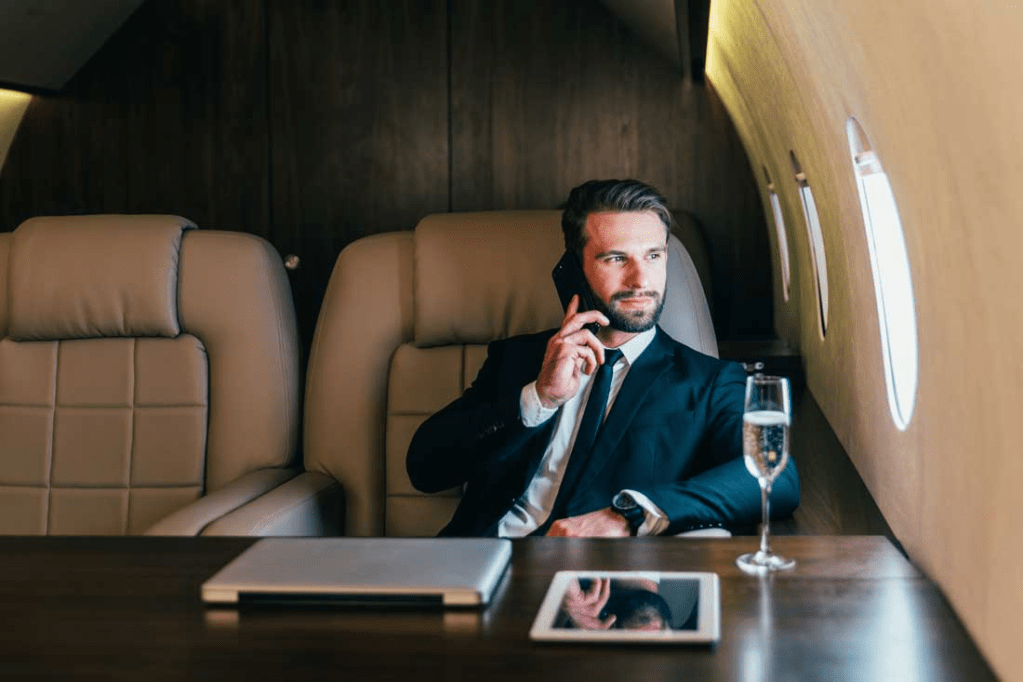 man flying on a private jet representing financial freedom