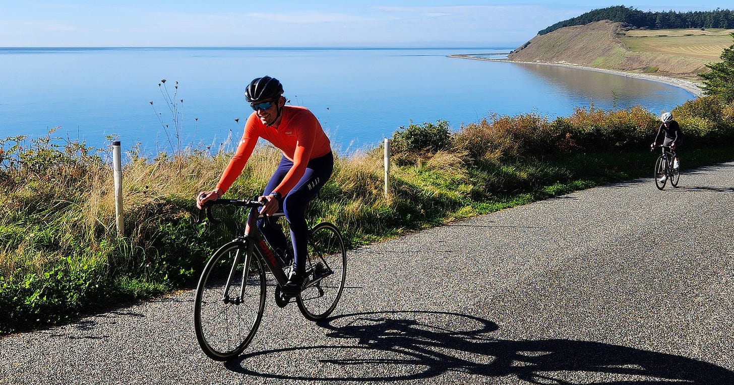Cyclist riding on a rural road on Whidbey Island.