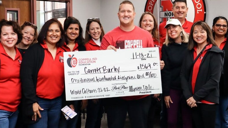Coppell ISD Education Foundation volunteers present a giant check to Coppell Middle School North teacher Garrett Barley Coppell ISD Education Foundation volunteers present a giant check to Coppell Middle School North teacher Garrett Barley