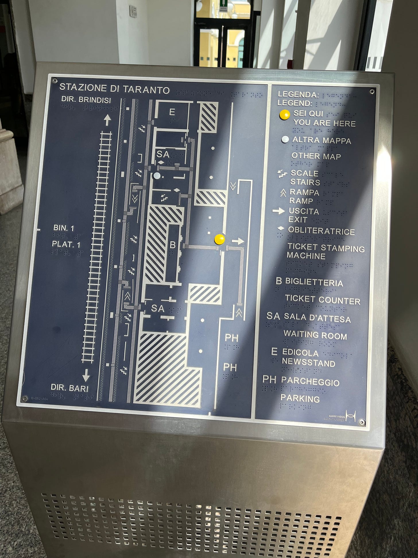 Photo showing a tactile layout diagram with Braille at Taranto station. Photo showing a tactile layout diagram with Braille at Taranto station.