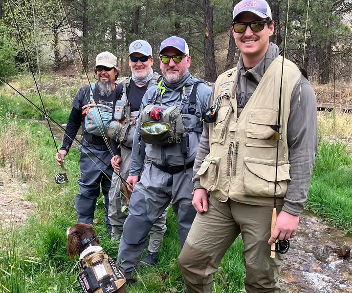 Four men in fly fishing gear stand in the sacramento mountains near the rio peñasco 