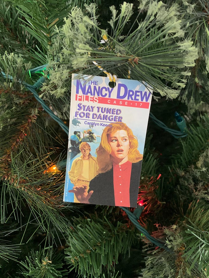 A row of Nancy Drew & Hardy Boys books + a Nancy Drew book cover Christmas tree ornament