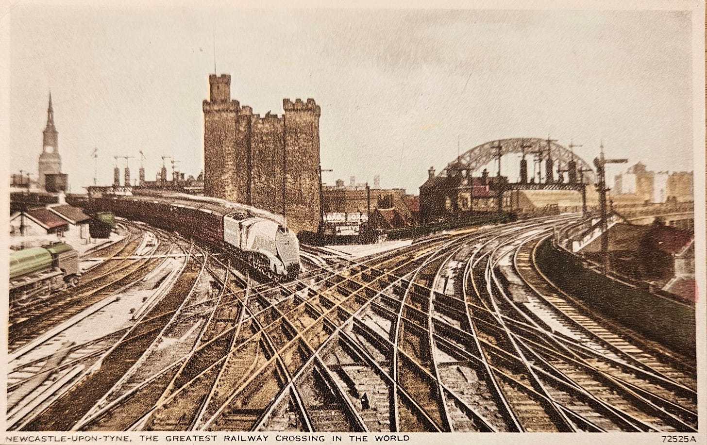 Historic view of Newcastle-upon-Tyne railway crossing, featuring multiple train tracks and the iconic Tyne Bridge in the background.