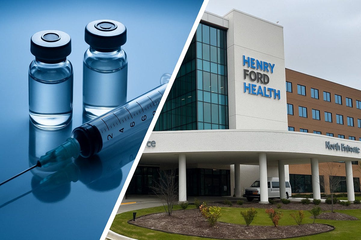 Two clear glass vials containing liquid and a syringe with needle on a reflective surface on the left side, paired with a modern multi-story building featuring large glass windows and blue Henry Ford Health signage on the right side, set against a landscaped area with grass and a parked white vehicle nearby.