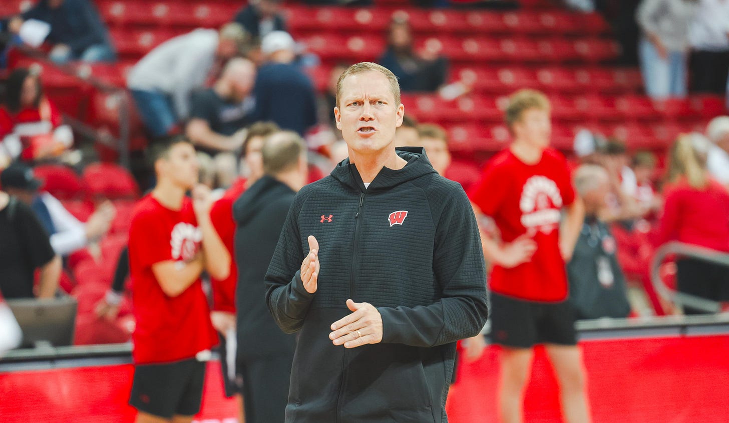 Wisconsin Badgers associate head coach Joe Krabbenhoft standing on the court before a game. Photo credit: Dane Sheehan.