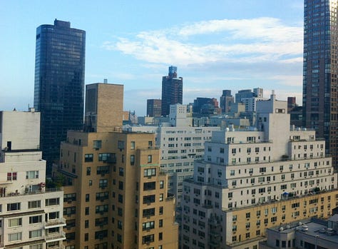 Three pictures, all of towering skyscrapers against blue skies