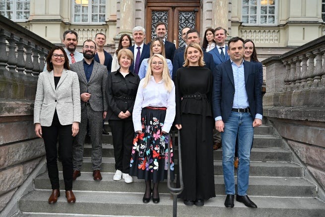 A group of people standing on stairs

Description automatically generated