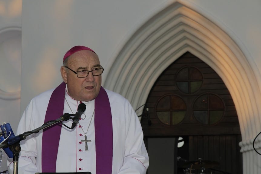 A catholic priest speaks in church.