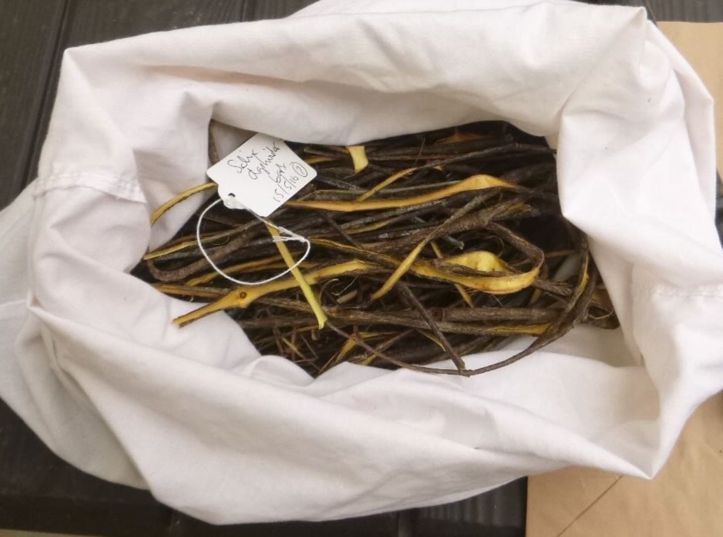 Strips of willow bark in a pillowcase with a label