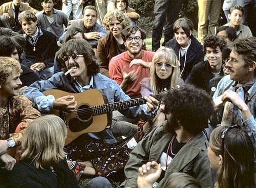 George Harrison & wife Patti Boyd, performing for a crowd of fans in San Francisco during the 1967 “Summer of Love.”
