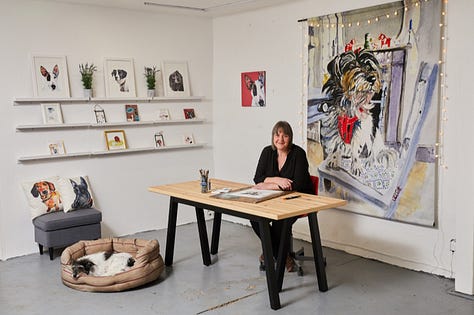 Photos of Jo Scott and her dog Thomasina with her dog art in her studio from 2018