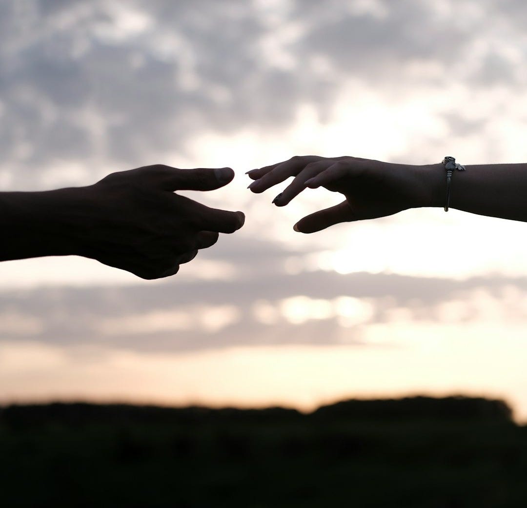 persons hand with heart shaped sign