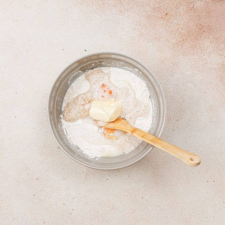 Bowl of flour, butter eggs and baking soda.