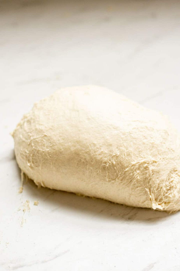Butter cubes in dough. A slab of kneaded dough.