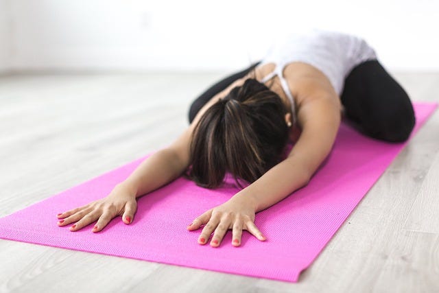 Young woman doing Yoga at home.