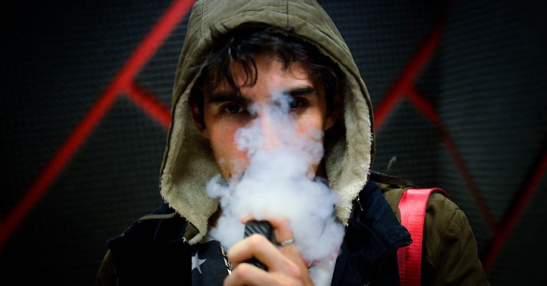 man in hoodie vaping man in hoodie vaping