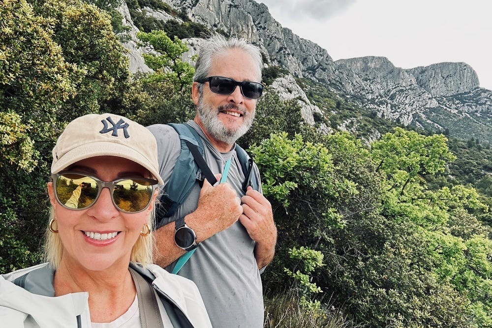 Kelly and Nigel Benthall hiking near the limestone cliffs of Aix-en-Provence during their slow-travel year abroad.