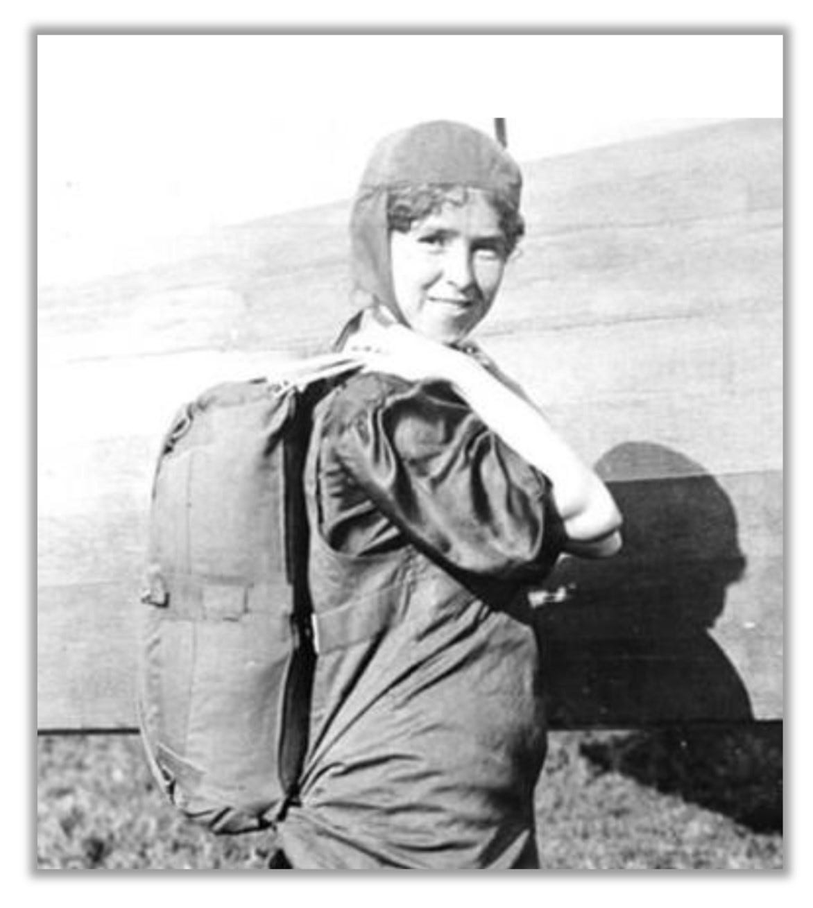 Tiny Broadwick poses with a parachute (looks like a backpack) on her back. 
