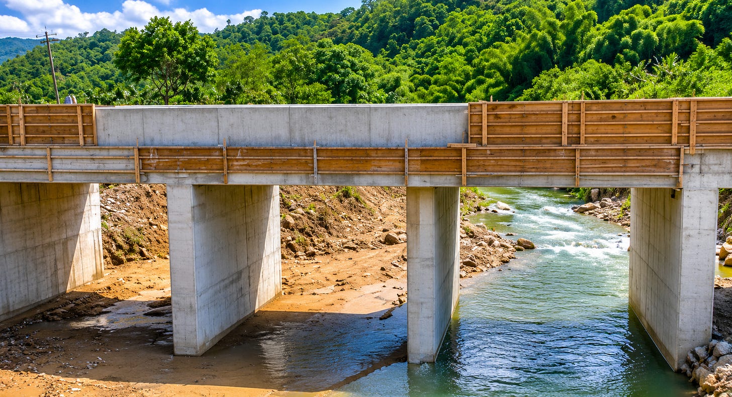 A newly constructed bridge spans a rural Jamaican river valley, symbolising resilience, connectivity and infrastructure renewal in the wake of Hurricane Melissa. A newly constructed bridge spans a rural Jamaican river valley, symbolising resilience, connectivity and infrastructure renewal in the wake of Hurricane Melissa.