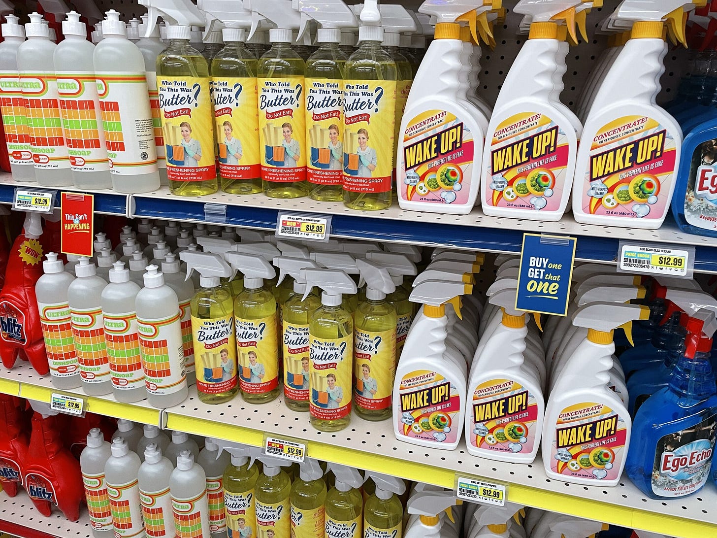 Shelves inside Omega Mart displaying surreal cleaning products like "WAKE UP!" and "Who Told You This Was Butter?"