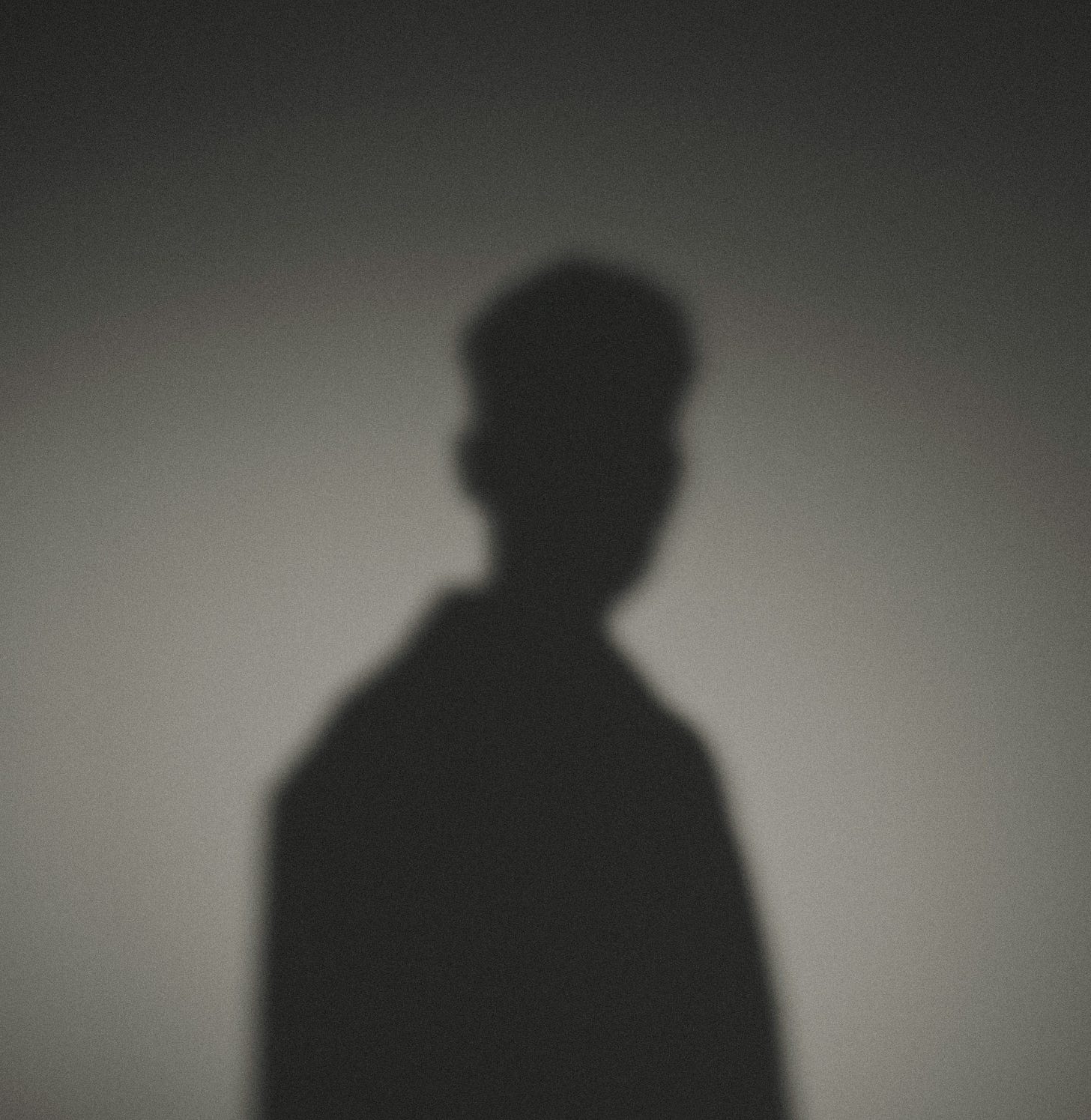A shadow of a man standing in the dark