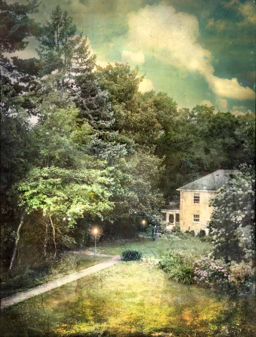 David A. Douglas, Marcy’s Yard, 2019. A lawn surrounded by tall trees and the side of a yellow house on a sunny day with gas lamps illuminated. David A. Douglas, Marcy’s Yard, 2019. A lawn surrounded by tall trees and the side of a yellow house on a sunny day with gas lamps illuminated.