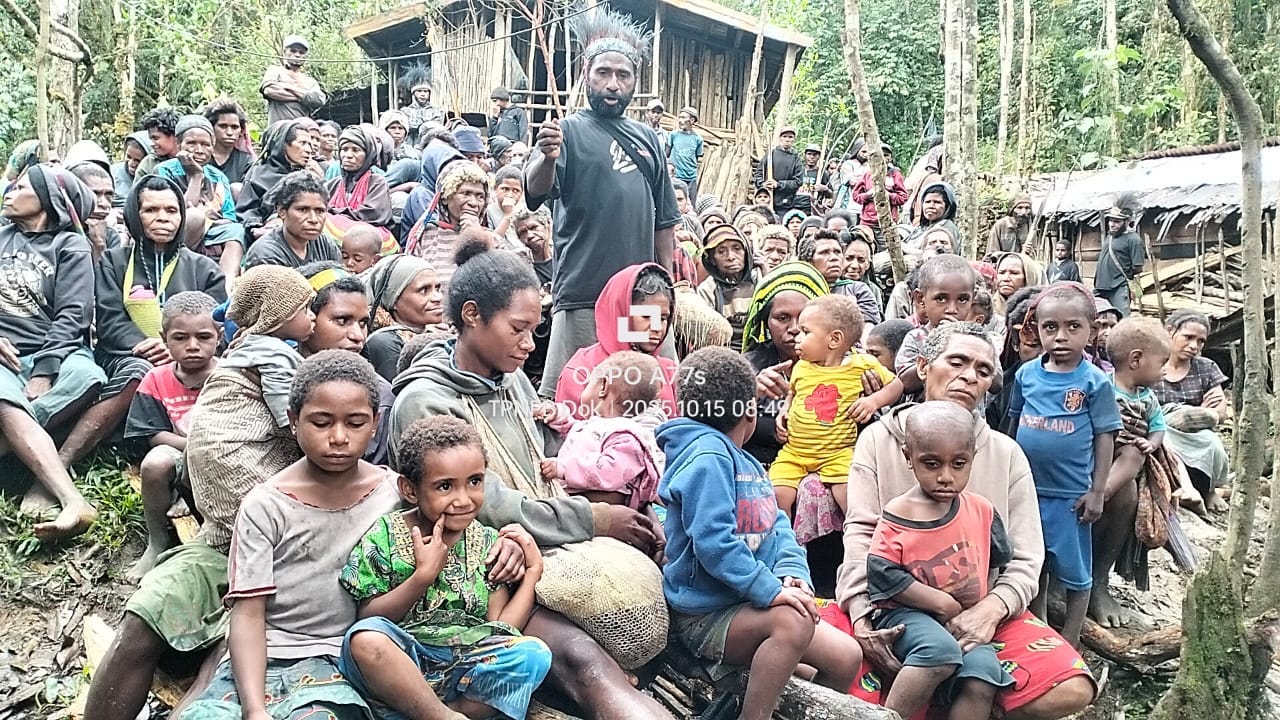 Lamek Taplo (standing) in jungle camp