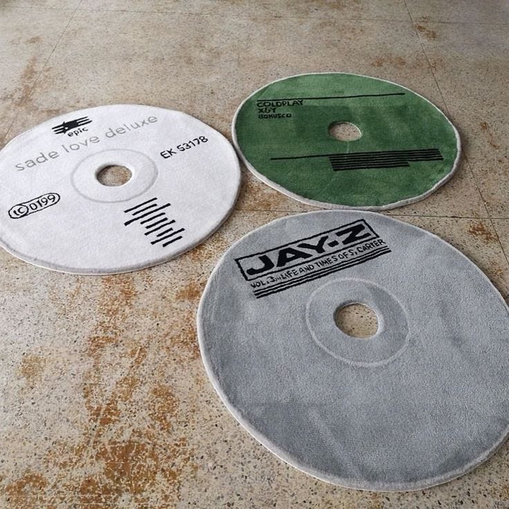 Sean Brown Curves CD Rugs, including Love Deluxe by Sade, X&Y by Coldplay and Vol. 3... Life and Times of S. Carter by Jay Z.