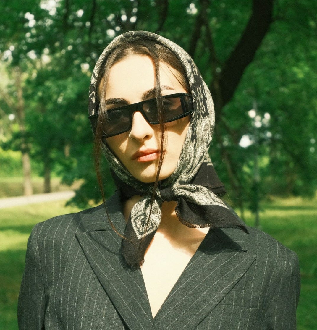 a mannequin wearing a suit and tie in a park a mannequin wearing a suit and tie in a park