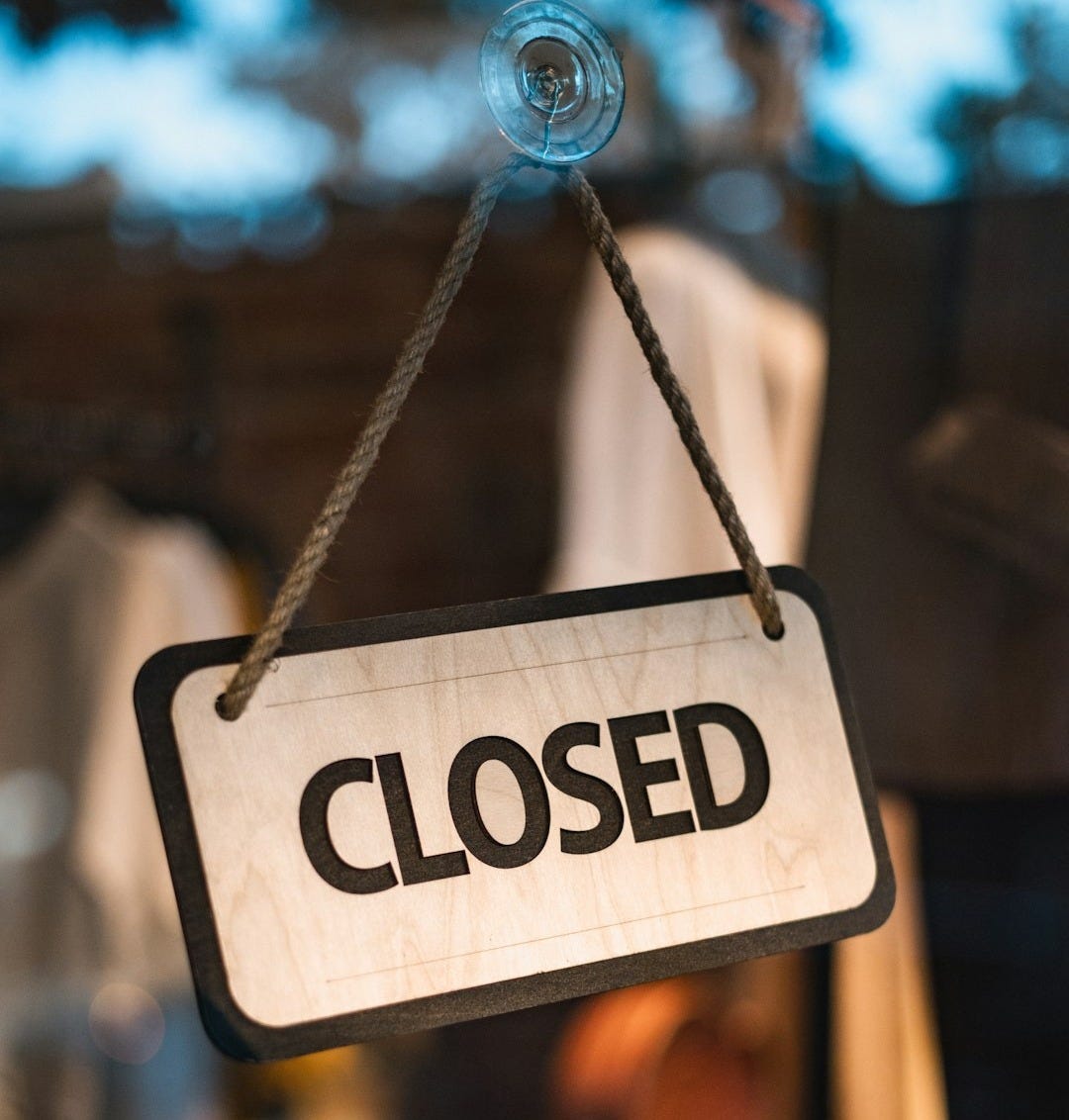 A close up of a closed sign hanging from a rope A close up of a closed sign hanging from a rope
