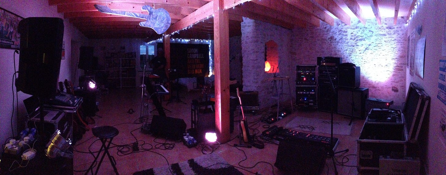 A studio with musical equipment and fairy lights