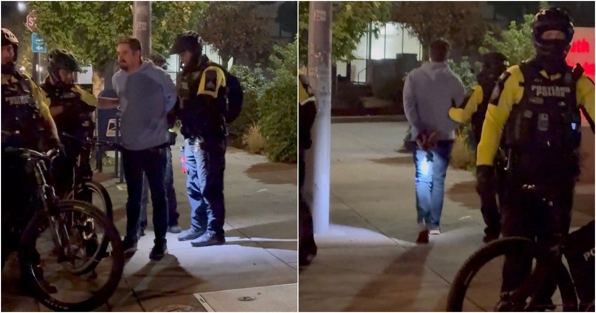 Police officers apprehending a man in a hoodie on a city street at night, with officers on bicycles present. Police officers apprehending a man in a hoodie on a city street at night, with officers on bicycles present.