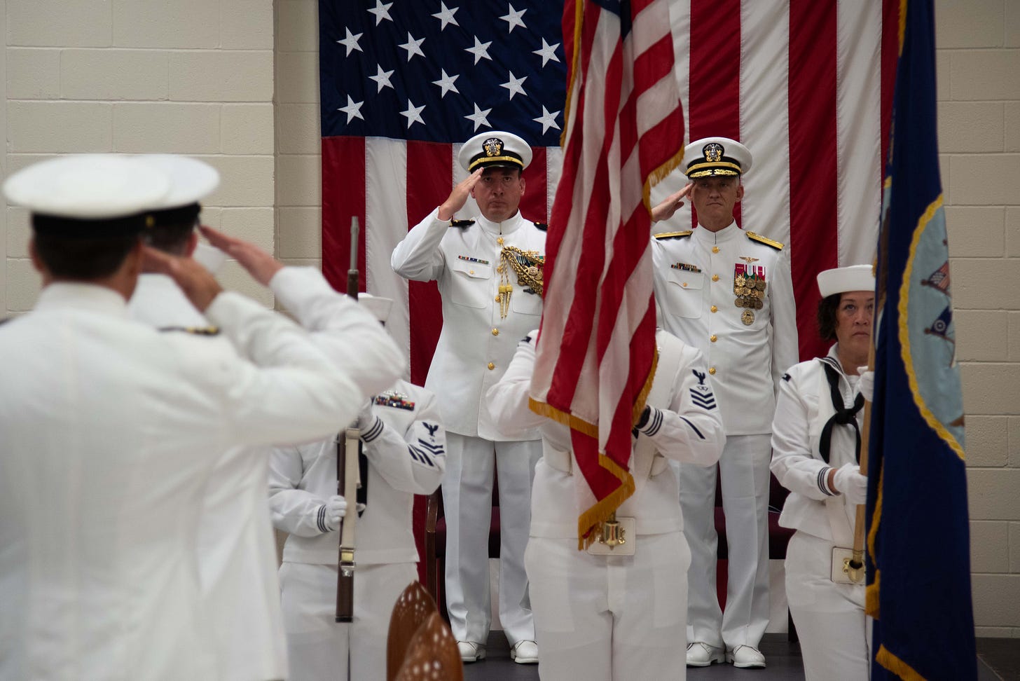 Matthew Long standing in military dress uniform during his retirement ceremony after twenty-four years in the U.S. Navy. Matthew Long standing in military dress uniform during his retirement ceremony after twenty-four years in the U.S. Navy.