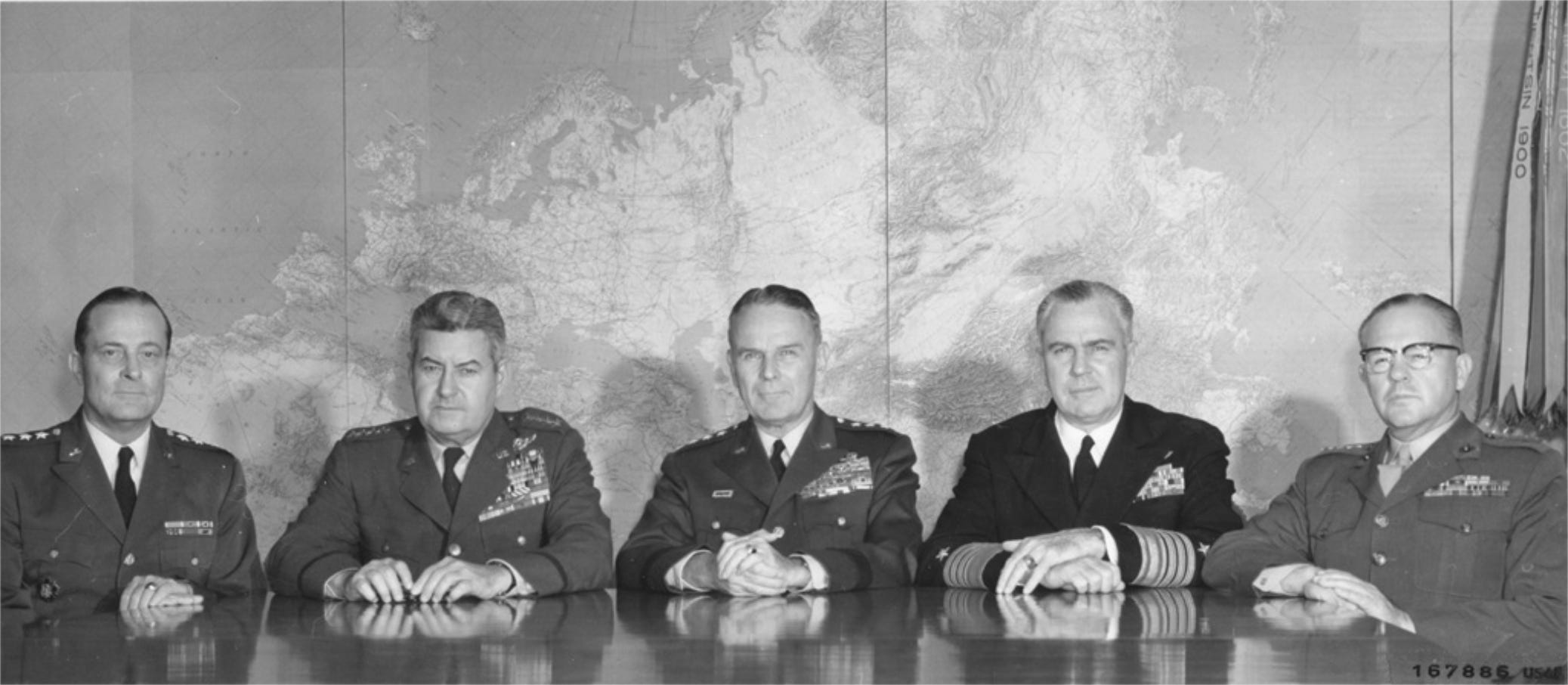 "Members of the Joint Chiefs of Staff in session at the Pentagon, Washington, D.C., November 19, 1962. Left to right: General Earle G. Wheeler, Chief of Staff, U.S. Army; General Curtis E. LeMay, Chief of Staff, U.S. Air Force; General Maxwell D. Taylor, USA, Chairman, Joint Chiefs of Staff; Admiral George W. Anderson, Jr. Chief of Naval Operations; and General David. W. Shoup, Commandant, U.S. Marine Corps." Source: National Archives, Still Pictures Branch, Record Group 342-B, box 571 "Members of the Joint Chiefs of Staff in session at the Pentagon, Washington, D.C., November 19, 1962. Left to right: General Earle G. Wheeler, Chief of Staff, U.S. Army; General Curtis E. LeMay, Chief of Staff, U.S. Air Force; General Maxwell D. Taylor, USA, Chairman, Joint Chiefs of Staff; Admiral George W. Anderson, Jr. Chief of Naval Operations; and General David. W. Shoup, Commandant, U.S. Marine Corps." Source: National Archives, Still Pictures Branch, Record Group 342-B, box 571