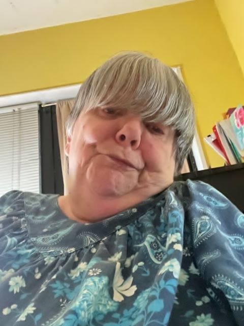 Picture of the author shrugging her shoulders and making a funny face