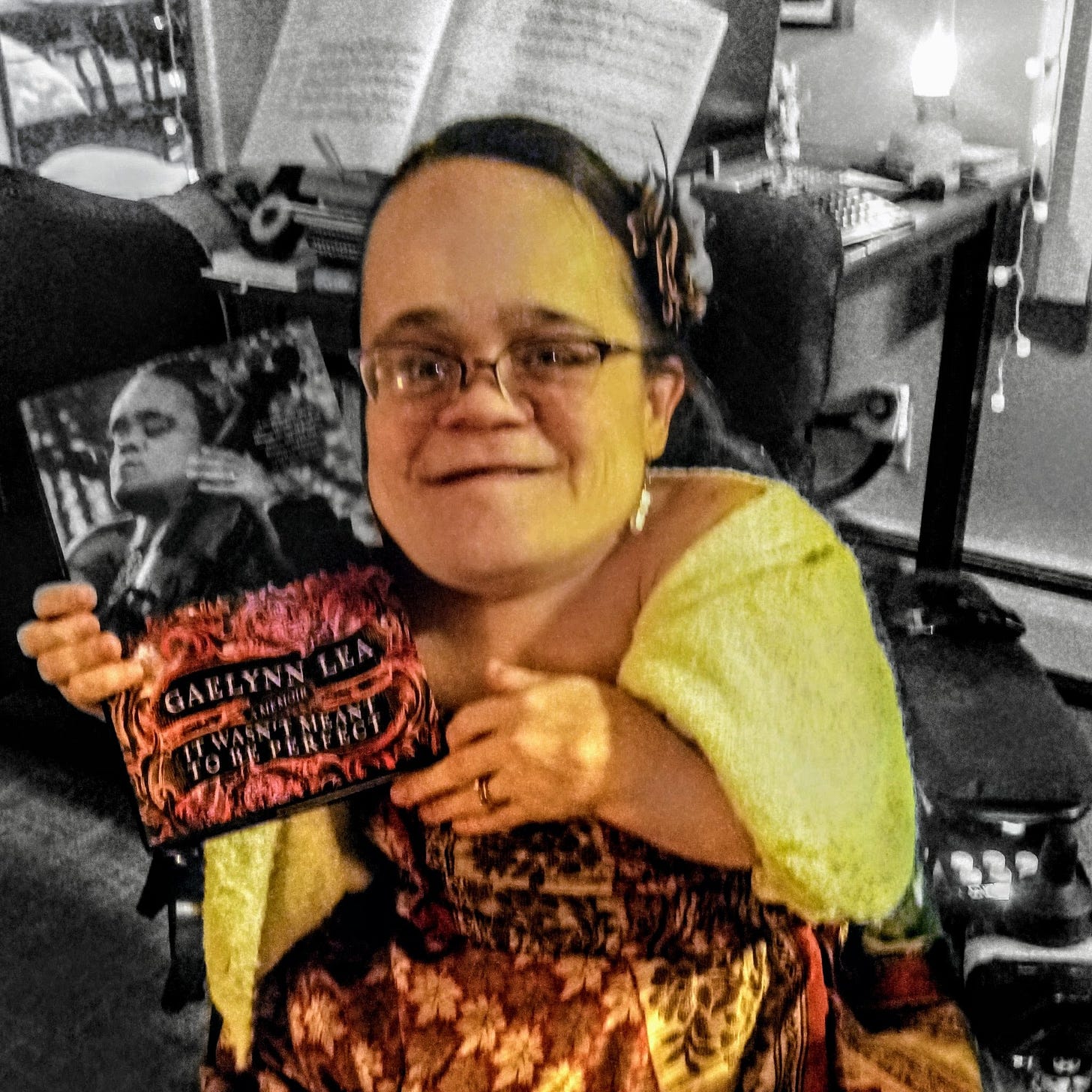 A picture with a black and white background and then Gaelynn is in color, holding her book and smiling.