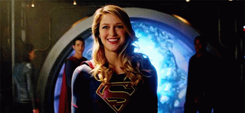 a woman wearing a superman costume is smiling