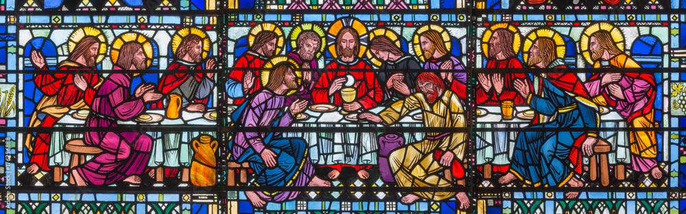 LONDON, GREAT BRITAIN - SEPTEMBER 16, 2017: The stained glass of Last Supper the Pantokrator in church St Etheldreda by Joseph Edward Nuttgens (1952). LONDON, GREAT BRITAIN - SEPTEMBER 16, 2017: The stained glass of Last Supper the Pantokrator in church St Etheldreda by Joseph Edward Nuttgens (1952).