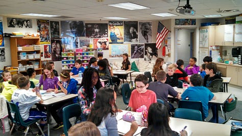Students working on various projects throughout a classroom. 