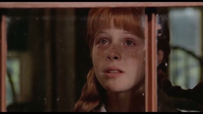 Pippi Longstocking with red hair and freckles looking out window with tears in her eyes, talking to her mom's spirit in the sun and clouds