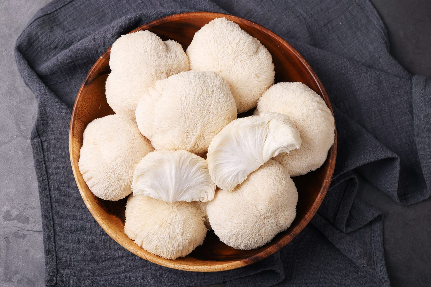 lions mane mushrooms in wood bowl