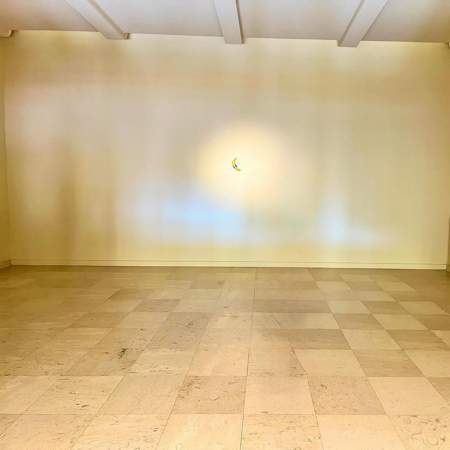 photo of Maurizio Cattelan's Comedian (duct tape banana) on a gallery wall