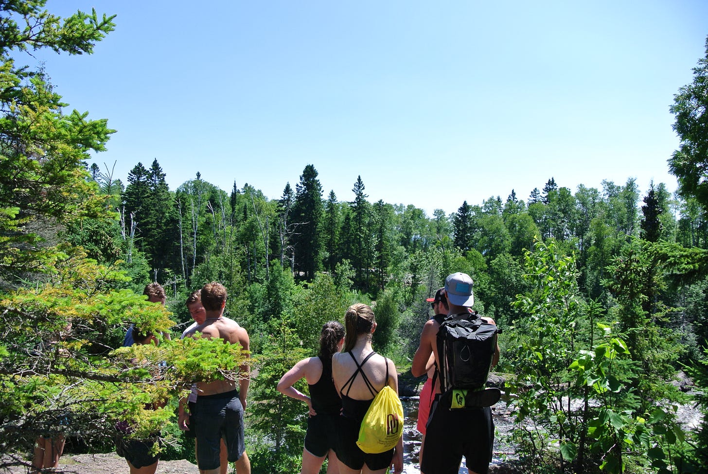 All of Lisa's friends together, staring off at temperance river among a backdrop of green trees. All of Lisa's friends together, staring off at temperance river among a backdrop of green trees.