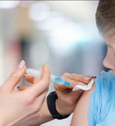 Child receiving shot in arm