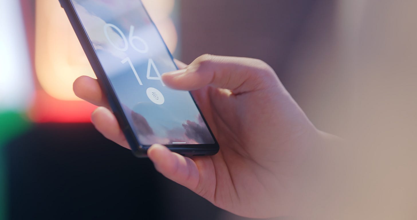 User authenticating and unlocking his phone with a fingerprint scanner