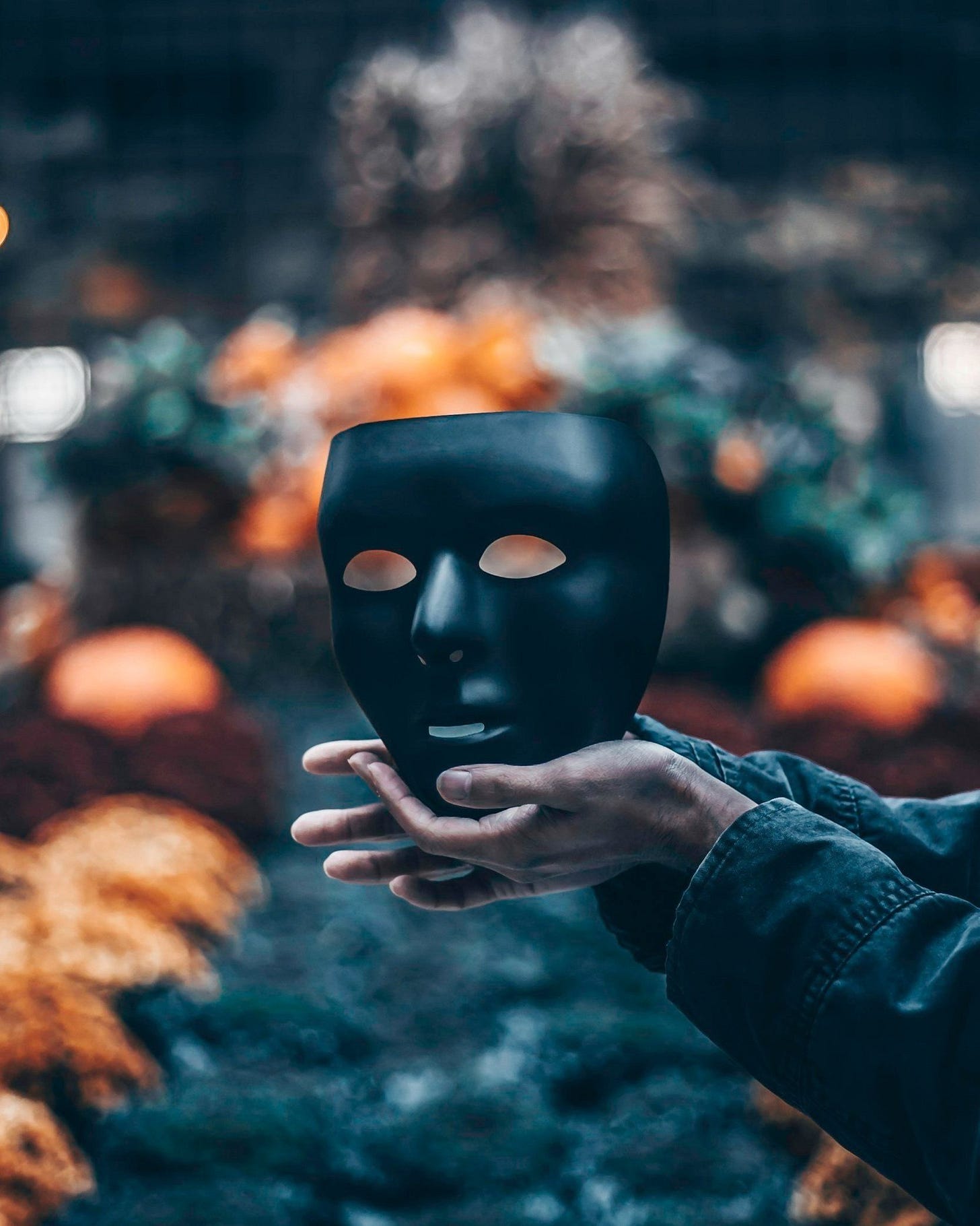 Hands holding a black mask Hands holding a black mask
