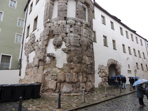 photos of buildings, a cathedral. a plaque, and a gravestone embedded in a wall